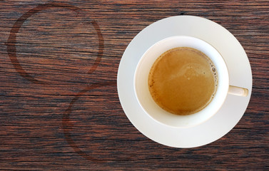 Top view of a cup of coffee on wooden table
