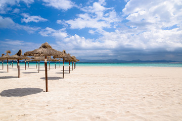 Umbrellas on sandy Alcudia beach, Majorca island, Spain