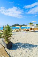 Sunchairs with umbrellas on Porto Giunco beach, Sardinia island