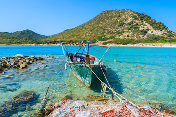Fishing boat on sea water at Punta Molentis bay, Sardinia island