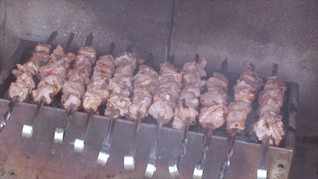 meat on a skewer fried on coals and looks delicious
