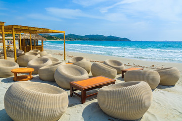 Chairs with tables in a beach bar in Porto Giunco bay, Sardinia