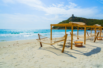 Sunchairs and hammocks on Porto Giunco beach, Sardinia island