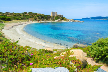 Beach with azure sea and castle on coast of Sardinia island © pkazmierczak