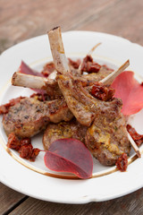 Grilled rack of lamb garnished with autumn leaves