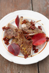 Grilled rack of lamb garnished with autumn leaves