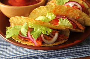 Mexican food - tacos with meat, lettuce and tomatoes