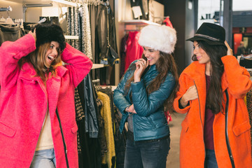 Three Women in a Clothing Store with Colorful Coats