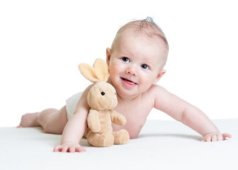 baby boy lying with plush toy