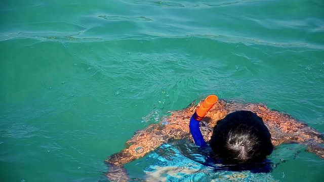 Boy diving in a sea