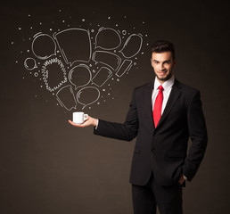 Businessman holding a white cup with speech bubbles