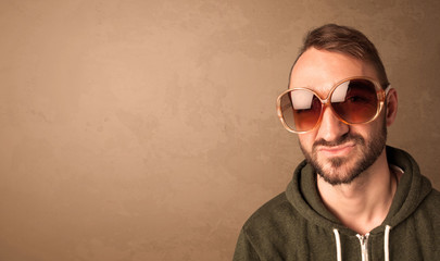 Portrait of a young funny man with sunglasses and copyspace