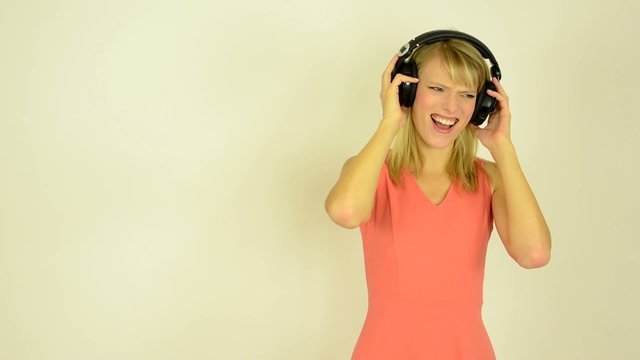woman listens horrible music with headphones - horrible music