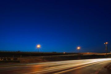 lighting of vehicle driving on asphalt road against beautiful bl