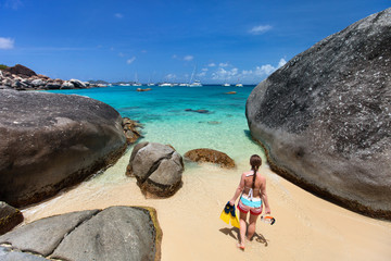 Woman with snorkeling equipment at tropical beach