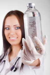 Woman doctor holding a glass bottle with a vaccine