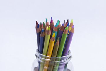 Artists coloured pencils in glass jar