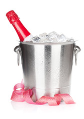 Champagne bottle in ice bucket and christmas decor