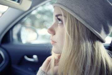 Fototapeta na wymiar beautiful young blond teen in the car