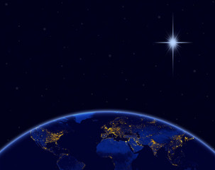Planet earth and Christmas star in night sky
