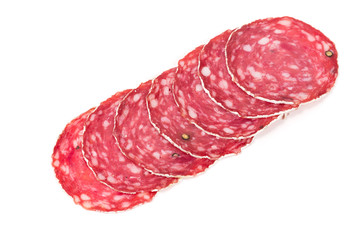 Slices of salami sausage on a white background