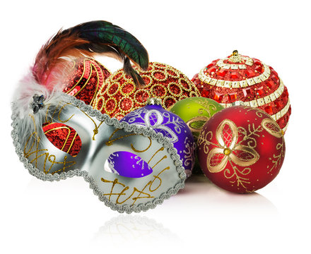 Christmas balls and carnival mask on the white background