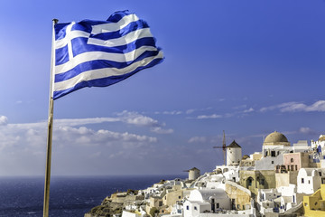 Village of Oia with Greek flag waving, Santorini Island