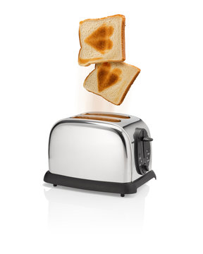 Roasted bread with heart symbol pops out from toaster.