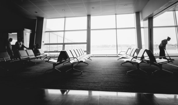 Monochrome photo of rows of seats at airport terminal