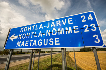 Road sign, summer landscape