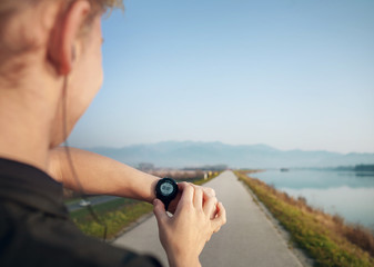 Runner starts his modern stopwatch before jogging