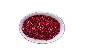 Pomegranate seeds in an oval clay plate