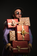Man clown carrying Christmas gifts