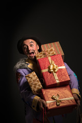 Fototapeta premium Man clown carrying Christmas gifts