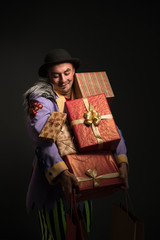 Man clown carrying Christmas gifts