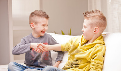 two babies shaking their hands as they were businessmen © Giulio_Fornasar