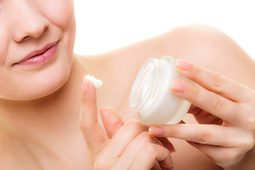 Skin care. Girl applying moisturizing cream