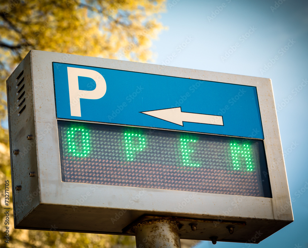 Wall mural open... parking sign in front a parking lot