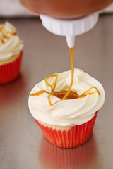 Salted caramel topping on vanilla cupcake