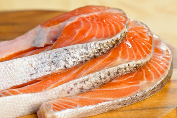 Delicious  portion of fresh salmon fillet on a wooden table