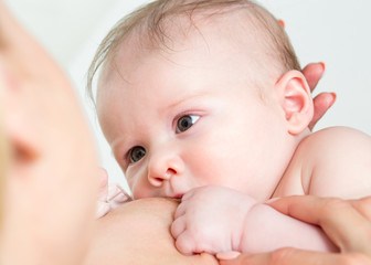 Baby feeds on mother's breasts milk