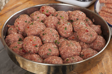 Raw italian style meatballs ready to be cooked in pasta sauce