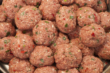 Raw italian style meatballs ready to be cooked in pasta sauce
