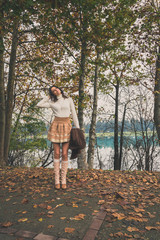 Beautiful young woman posing in a city park