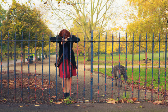 Sad woman with dog in park