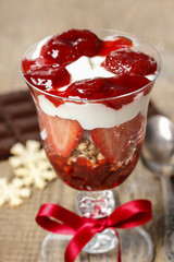 Layer strawberry and muesli dessert in glass goblet