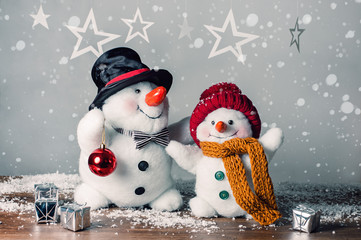 Two smiling snowmen  in the snow, no name toy