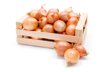 Yellow onions in wooden crate