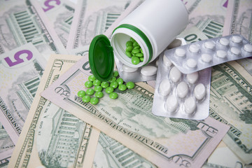 Tablets on a background of money. Medicine. Concept.