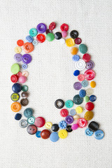 Letter Q of the alphabet of buttons of various shapes and colors